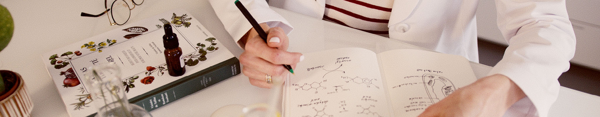 Dr. Natacha Bonjout writing in notebook about skincare formulations in laboratory 