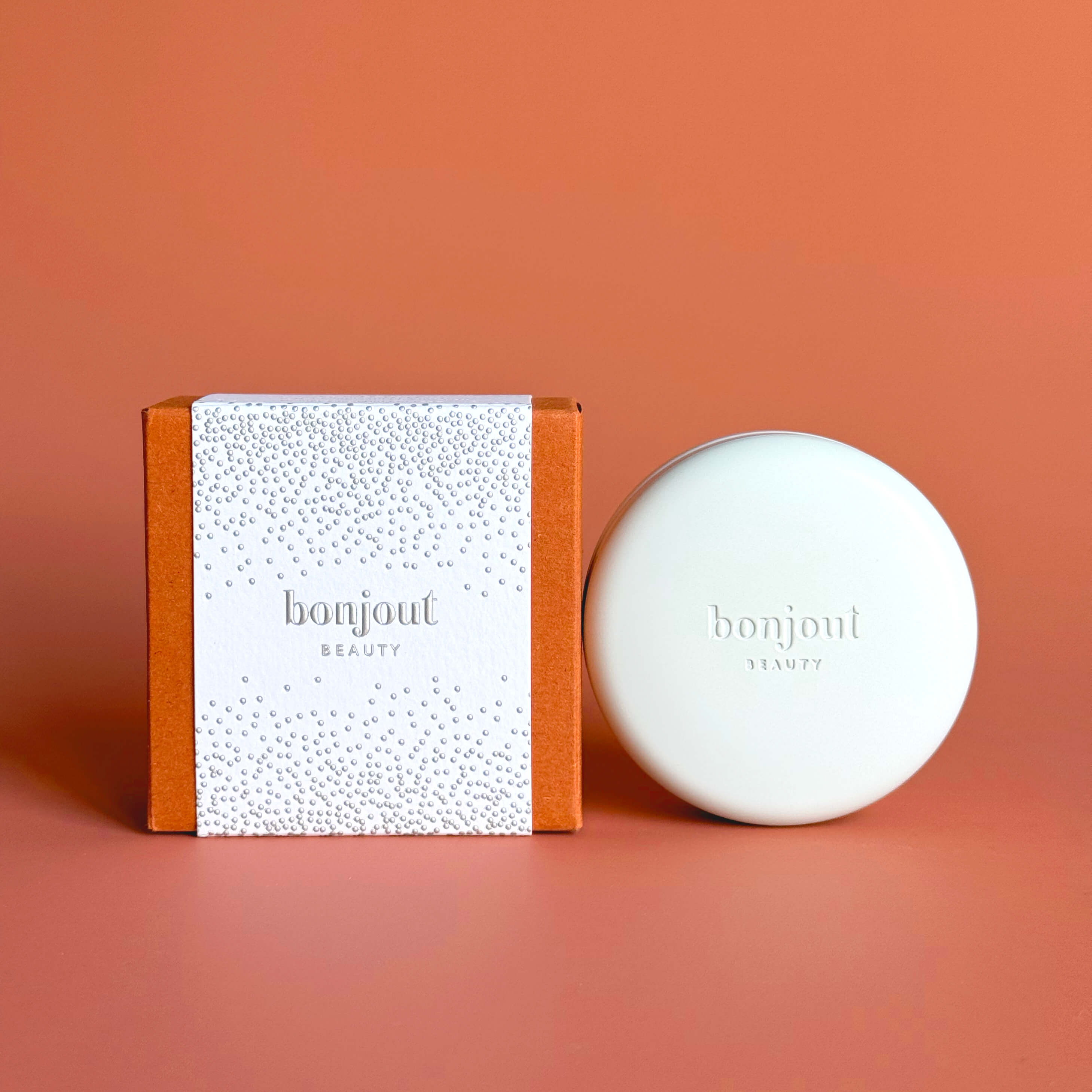 Bonjout Beauty&#39;s Le Balm Product next to Holiday Packaging 