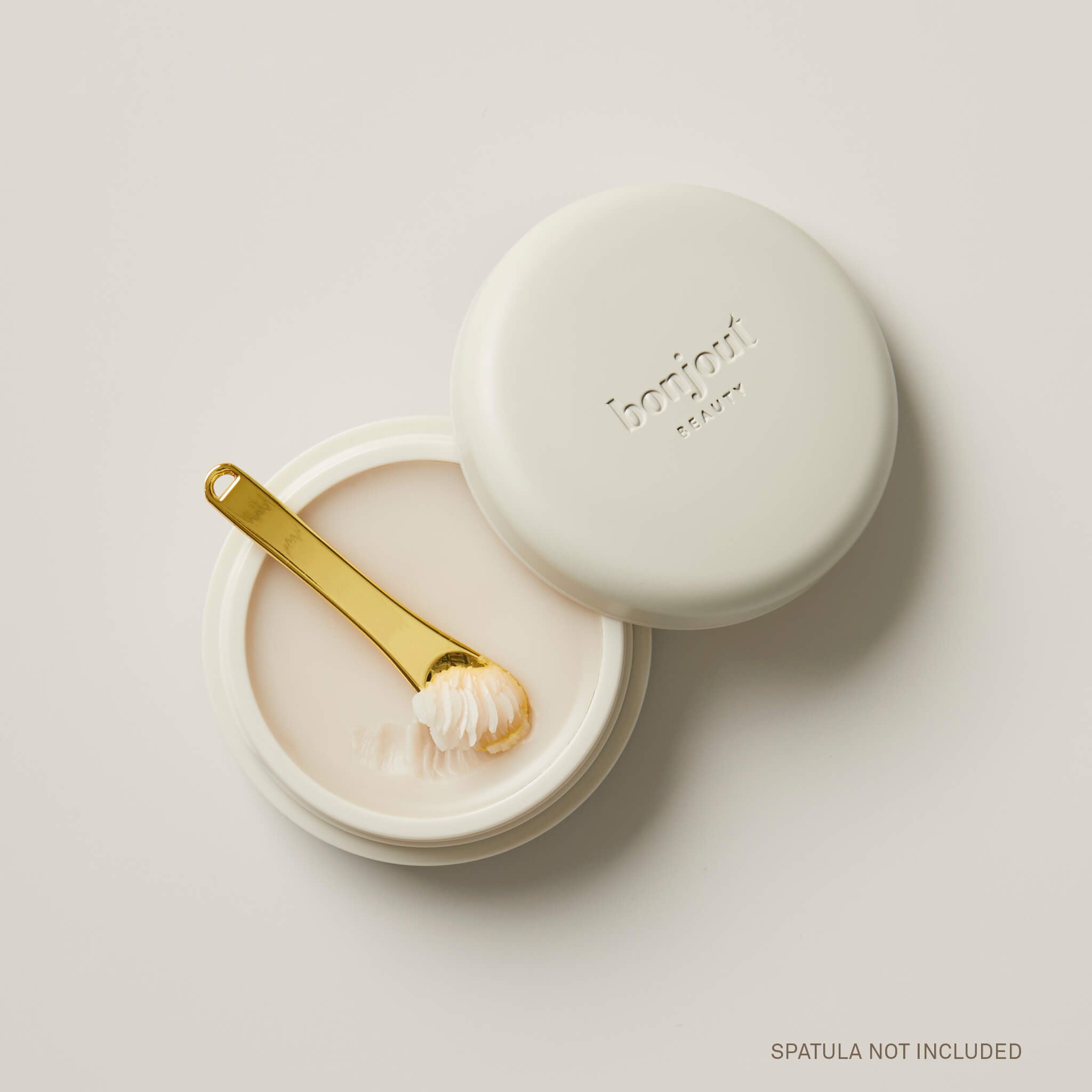 Bonjout Beauty&#39;s Le Balm product displayed open with golden spatula