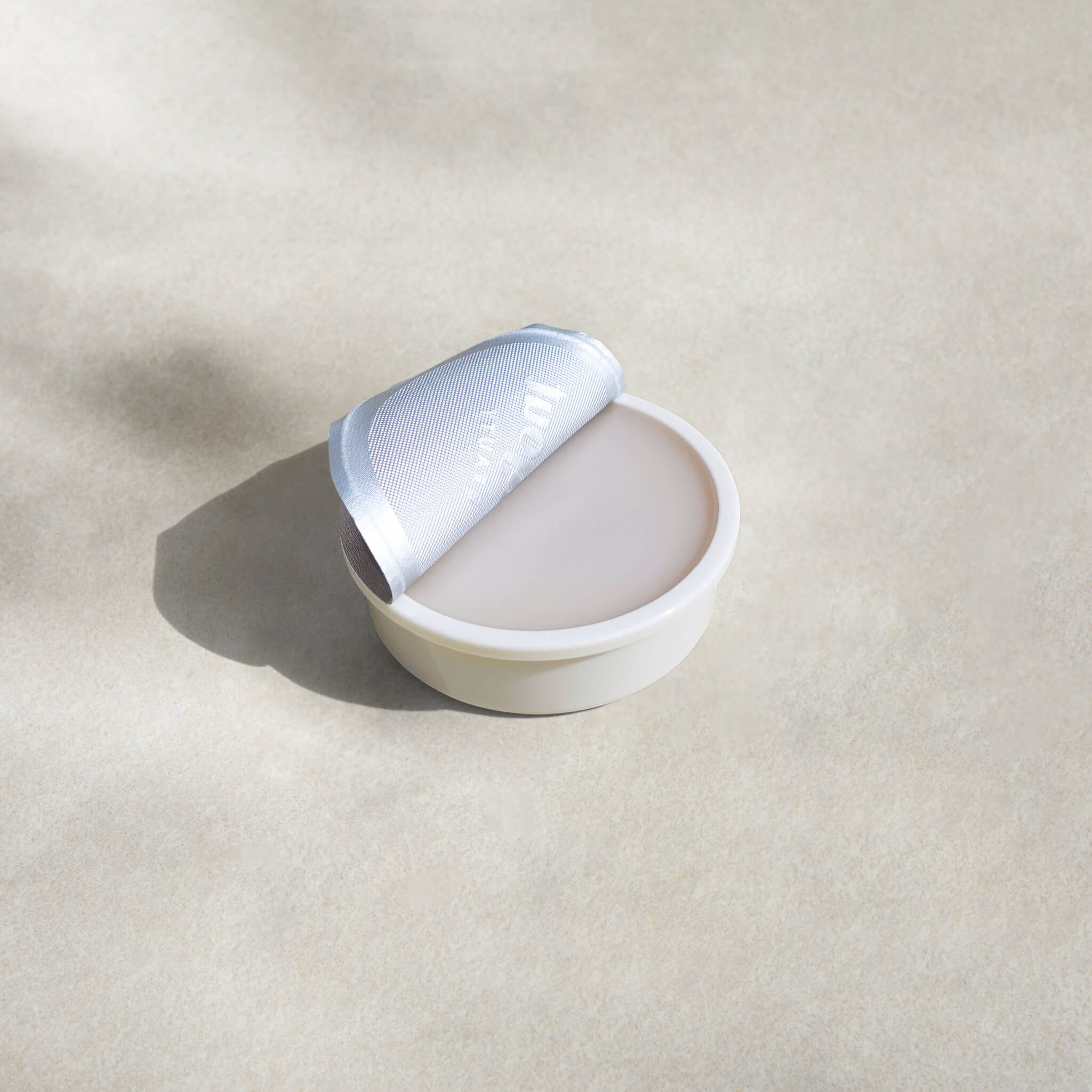 Bonjout Beauty&#39;s Le Balm product refill tin with lid pulled back